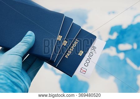 Immunity Passport, Risk-free Certificate Concept. Hand In Medical Gloves Holds Passports With Note C