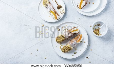 Traditional Italian Dessert Cannoli Siciliani On The Light Background, Top View Image With A Copy Sp