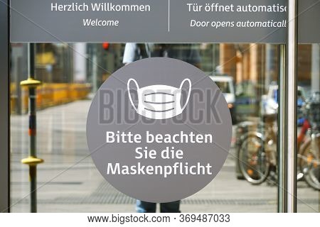 Hannover, Germany - May 21, 2020: German Language Sign On Entrance Door To Shopping Center Advises T