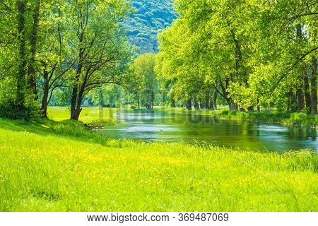 Beautiful River Gacka Flowing Between The Meadow Fields In Lika Region Of Croatia