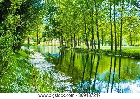 Beautiful River Gacka Flowing Between The Meadow Fields In Lika Region Of Croatia