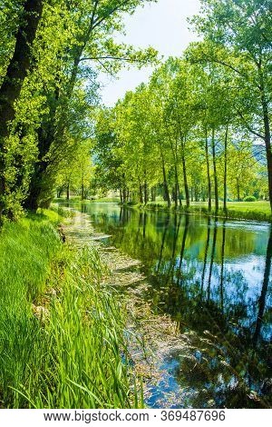 Beautiful River Gacka Flowing Between The Meadow Fields In Lika Region Of Croatia