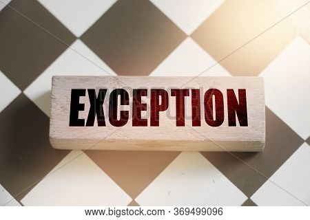 Wooden Blocks With The Text: Exception. Outstanding Abnormal Breaking The Rules Business Concept