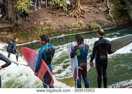 Munich, Germany - Sept 8, 2018: Man Surfing In The Waves Of The Eisbach River In Munich. It Forms A 