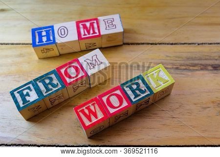 Conceptual Of Work From Home During Lockdown Directives During Virus Outbreak. Wooden Alphabet Cubes