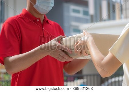 Woman Hand Accepting A Delivery Of Boxes From Delivery Man. Online Shopping And Express Delivery . Q
