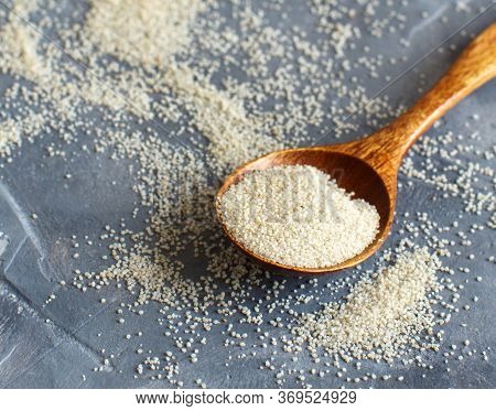 Raw Uncooked Fonio Seeds With A Spoon On Grey Background Close Up With Copy Space