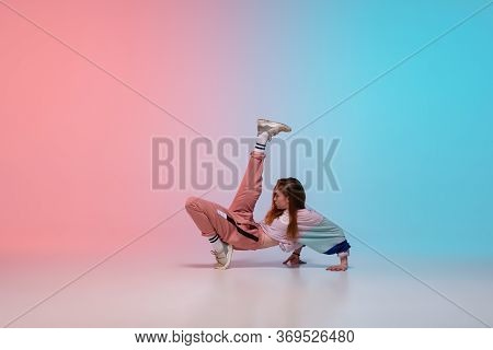 Beautiful Sportive Girl Dancing Hip-hop In Stylish Clothes On Colorful Gradient Background At Dance 
