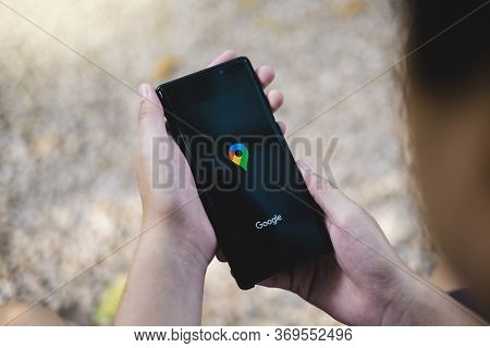 Rayong, Thailand, Apr 12,2020: A Man Holding Samsung Galaxy Note Smartphone For Using Google Maps Ap