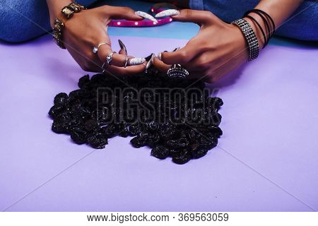 Woman Hands With Long Nails Manicure Holding Dry Fruits In Shape Of Heart On Purple Background