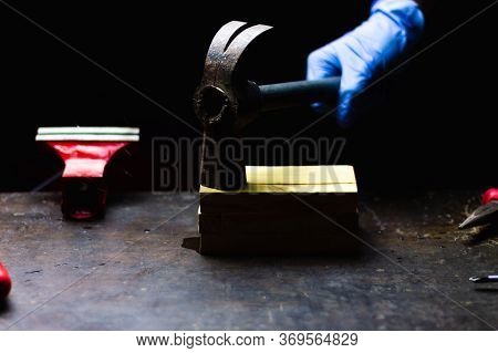 Hand With Blue Gloves Hitting With Hammer Wooden Box, Concept Of Repair, Maintenance And Crafts