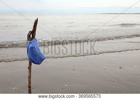 Surgical Mask Over The Stake By The Sea At The End Of The Lockdown By The Corona Virus