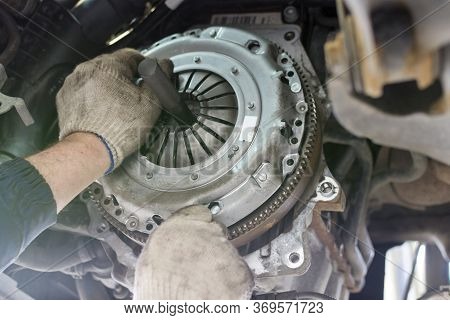 Car Repair In A Car Service. Replacing The Clutch Disc Of A Gearbox On A Car At A Service Station. H