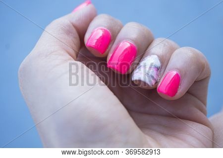 Womans Hand Showing Her Semipermanent Manicure. Pink Colour