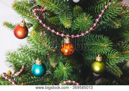 Christmas Decorations And Toys On Artificial Spruce, New Year Atmosphere.