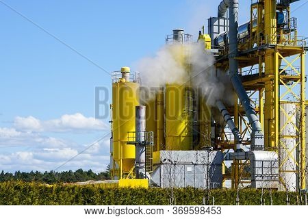 Operating Modern Cement Mix Preparation Plant Against A Blue Sky Background