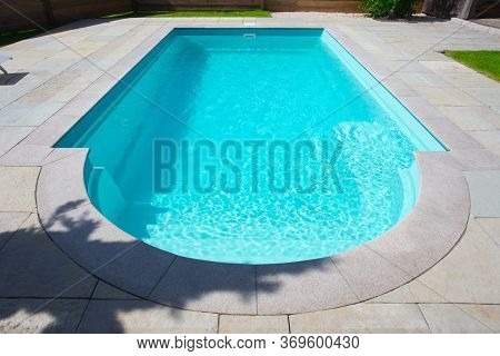 Closeup Of A Classic Private Swimmingpool In Garden In The Summer.