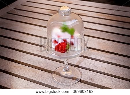 Creamy Strawberry Cake Decorated With Fresh Strawberries And Mint. In Glass Form In A Wooden Tabke