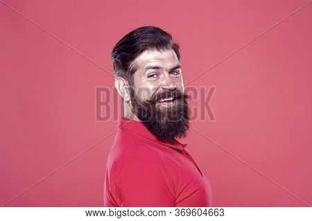 His Long Beard Works Well. Happy Hipster Red Background. Bearded Man With Stylish Hair. Beard Barber