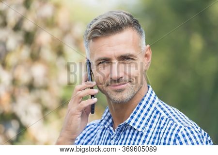 Answering A Call. Unshaven Man Talk On Cell Phone Outdoors. Taking Cell Phone Call. Mobile Or Cell P