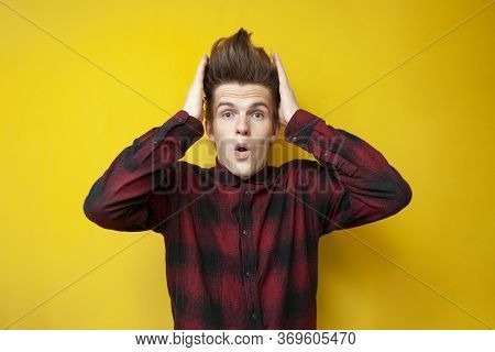 Crazy Guy With A Funny Hairstyle Is Surprised On A Yellow Isolated Background, Hipster With Strong H