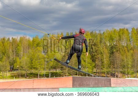 Fagersta, Sweden - Maj 26, 2020: Wakeboarder Flies In The Air On Wakeboard. Wakeboarding Is Extreme 