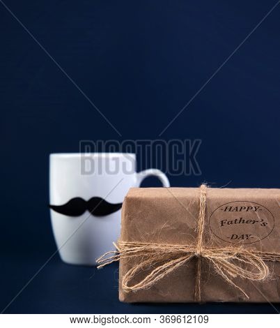 Happy Fathers Day Concept. Cup Of Coffee With Black Paper Mustache, Gift.