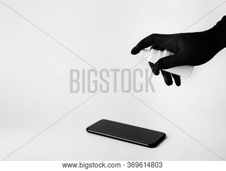Hand Sprays Solution On The Phone Screen To Disinfect. Free Space For Text