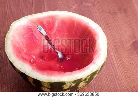A Sliced Red Ripe Watermelon With A Spoon Stuck In It. Spoon Ate Watermelon Like A Cup