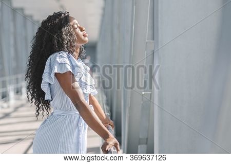 Taste Of Freedom. Side View Of Young Black Woman Standing With Closed Eyes In Airport Terminal After