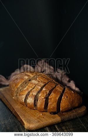 Sliced Fresh Bread With Golden Crust On A Wooden Board. Flour And Yeast.
