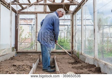 Cheerful Senior Elderly Man Digging Garden Spring Time