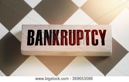 Wooden Block With The Word Bankruptcy. The Concept Of Judicial Punishment For Non-payment Of Debt. P
