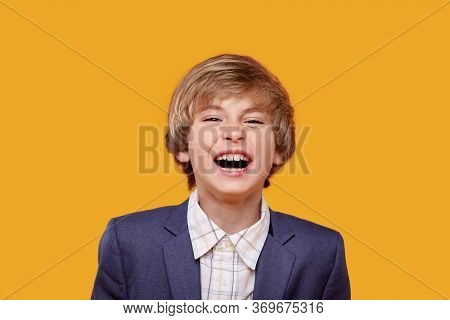 Loud Laughter Of A Beautiful Little Blond Boy In A White Shirt.