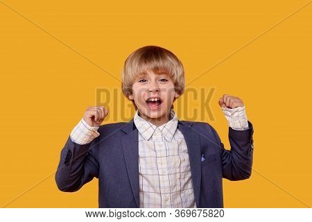 Hilarious Smiling Boy Blond Looks Into The Camera With His Hands Up.