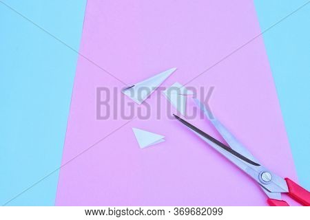 Step-by-step Process Of Cutting Out Snowflakes From White Paper For New Year And Christmas On The Ba