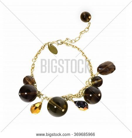 Women`s Wrist Bracelet Of Golden Chain, Gem Stones And Beads On White Background. Top View