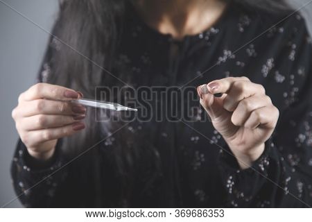 Young Ill Woman Hand Drug And Thermometer