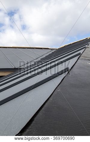 Close Up View Of Grey Folding Roof Under Construction On Waterproofing Layer