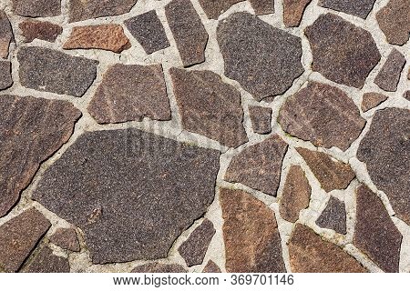 Close-up Of An Outdoor Flooring Made With Irregular Porphyry Slabs, Full Frame, Italy, Europe