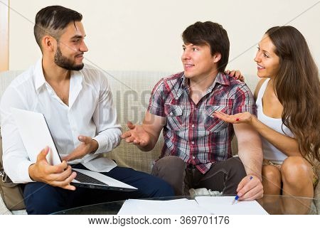 Smiling Salesman Try Hard To Sign A Contract With Merried Couple