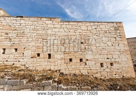 Closeup Of An Austrian Fortified Wall Made Of Irregular Stone Blocks With Arrowslits Or Loopholes