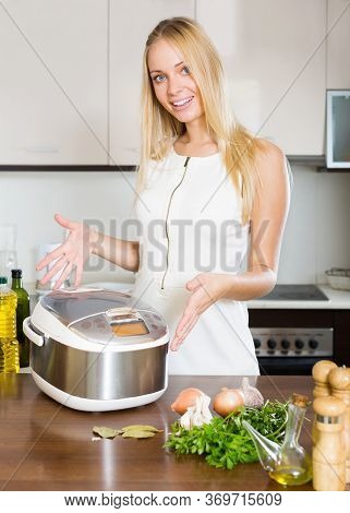 Happy Woman Using New Slo-cooker At Home