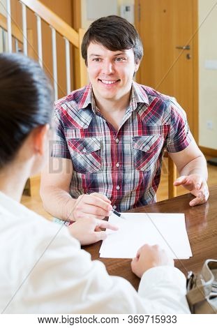 Happy Man Real Estate Agent Signing Agreement At Home