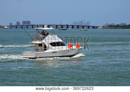 White Sport Fishing Boat With Open Sedan Bridge On The Florida Intra-coastal Waterway Off Of Miami B