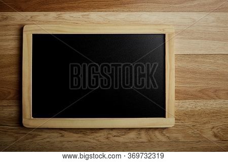 Blank Blackboard On The Wood Wall Background
