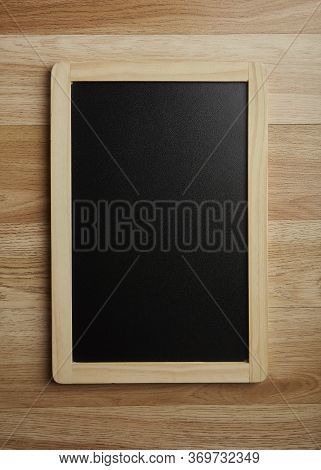 Blank Blackboard On The Wood Wall Background