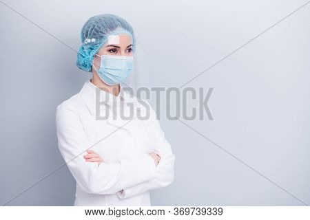 Photo Of Confident Professional Virologist Doctor Lady Arms Crossed Look Side Empty Space Wear Medic