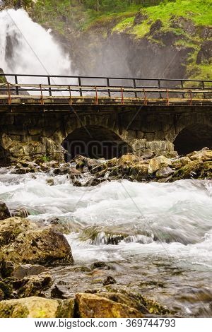 Norwegian Landscape. Waterfall Latefoss Latefossen With Stone Arched Bridge Road, Odda Hordaland Nor