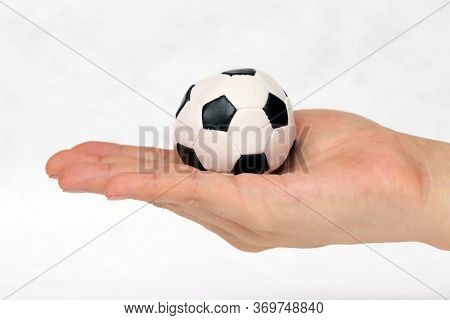 Mini Ball Of Football In Hand On White Background. Concept Of Sport Or The Game In Handle.